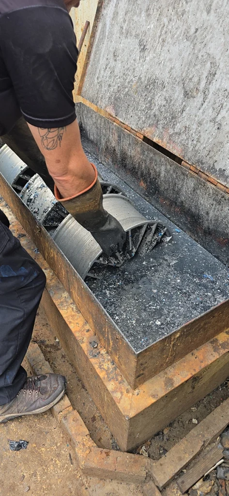 Metal part being machined with metal shavings below
