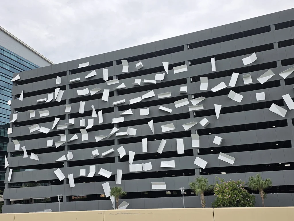 Rows of fabricated metal brackets arranged on a rack