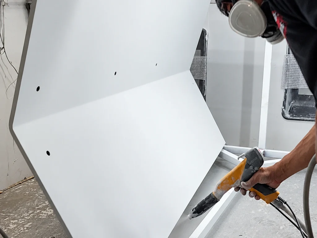Sandblasting a large metal panel
